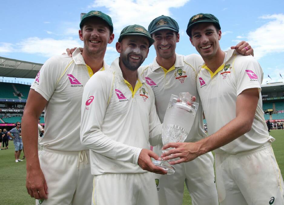Australian bowlers Josh Hazlewood, left, Nathan Lyon, Mitchell Starc and Pat Cummins hold the Ashes trophy in January. Photo: AP