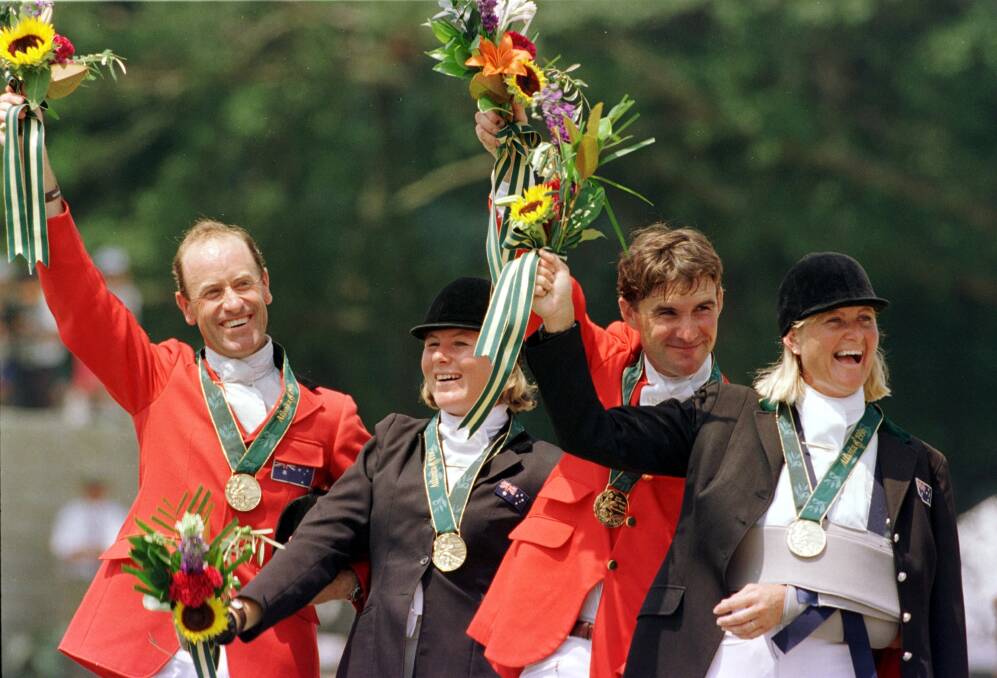 Australian equestrians (left to right) Andrew Hoy, Wendy Schaeffer, Phillip Dutton and Gillian Rolton jubilant in the wake of their gold medal win at the Atlanta Olympics. Photo: Ray Kennedy