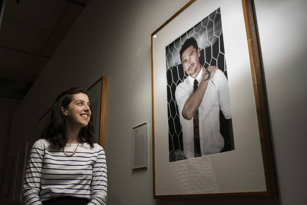 All aflutter: Amelia Thompson eyes Harry Kewell's portrait at the National Portrait Gallery ahead of The Hottest 100 Party on Australia Day.  Photo: Rohan Thomson