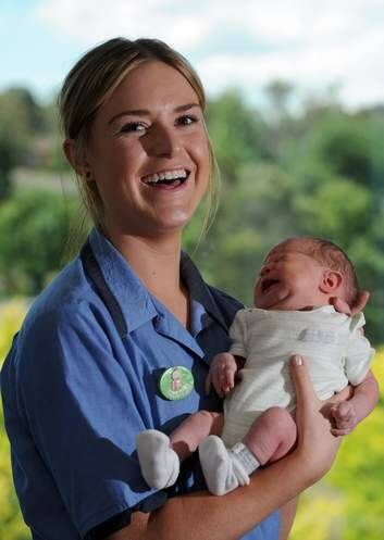 Graduate midwifery nurse, Rachael Williams, 21, of Queanbeyan, holds baby Baran (surname) at the Centenary Hospital for Women and Children. Photo: Graham Tidy
