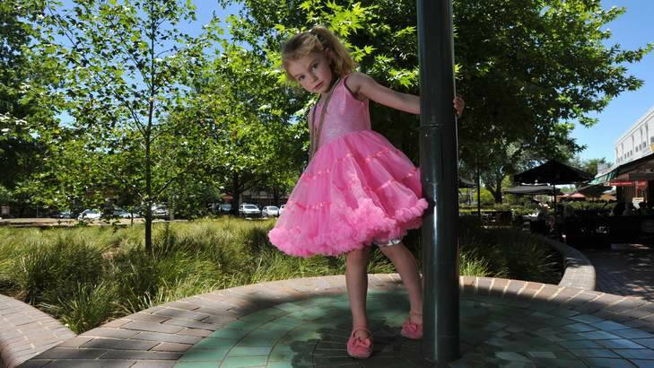 Ivy Hart, 3, from Queanbeyan, plays on a brick wall. Photo: Graham Tidy