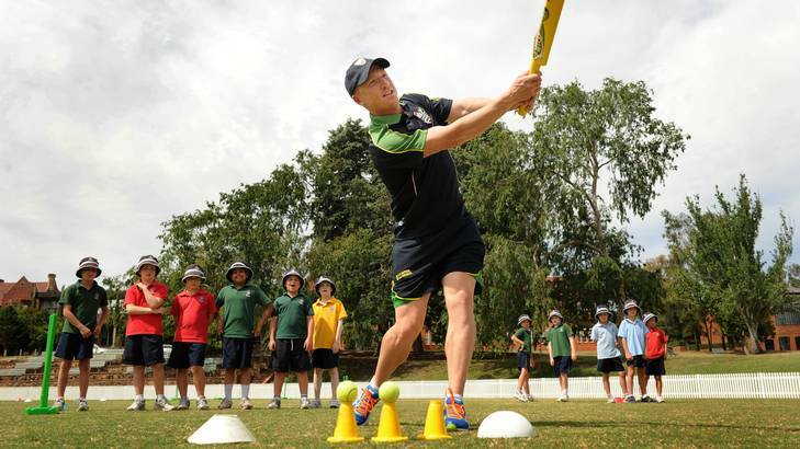 Brad Haddin helps Canberra Grammar students during a Milo Cricket training session. Photo: Colleen Petch
