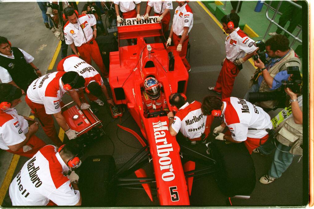 Ferrari mechanics work on Michael Schumacher's car at Albert Park in 1997. Photo: Mark Wilson