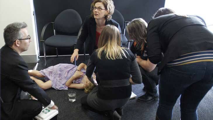 First aid is offered to a young girl who fainted at a press conference with Kevin Rudd in Perth. Photo: Andrew Meares
