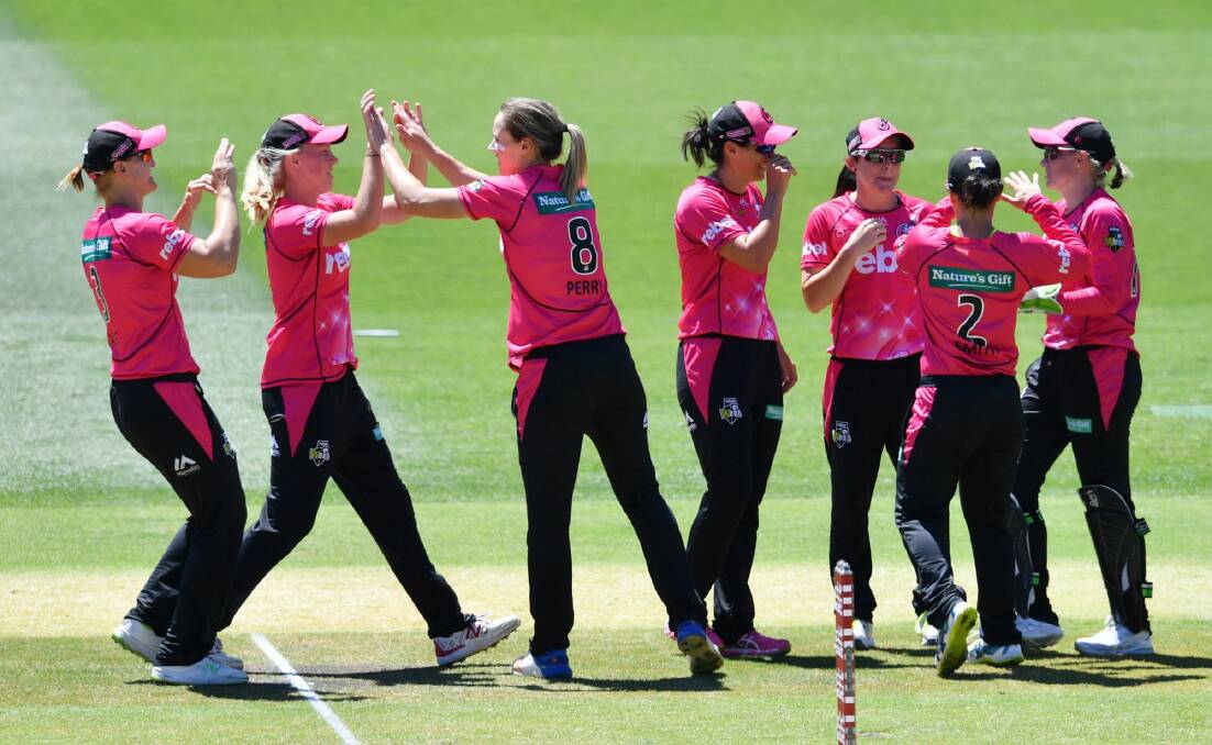 On the way: Sixers players celebrate the dismissal of Natalie Sciver. Photo: David Mariuz