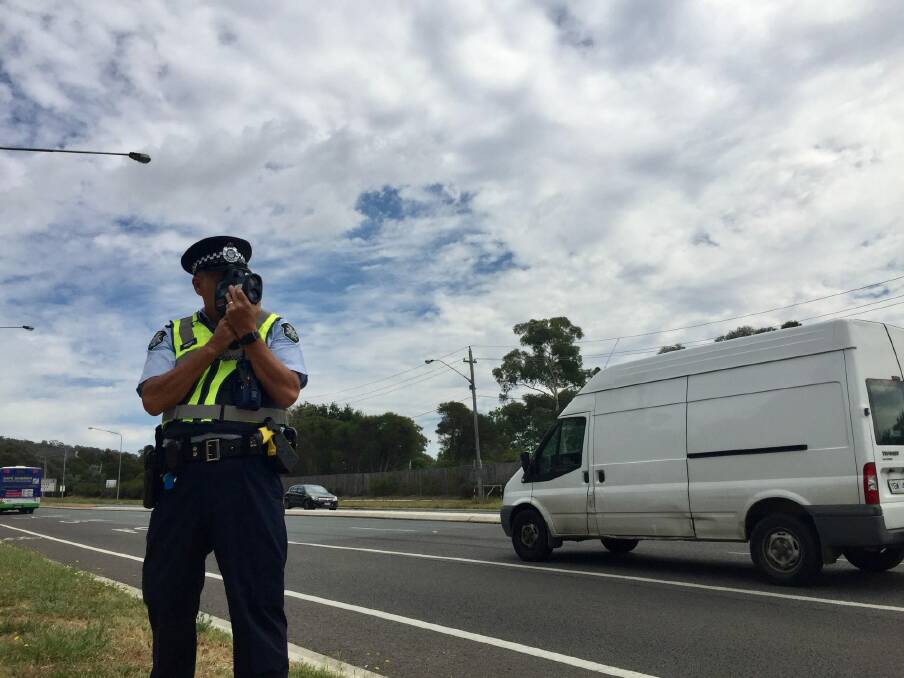 An ACT policing sergeant from Road Safety Operations checks drivers speeds on Barry Drive. Photo: Finbar O'Mallon