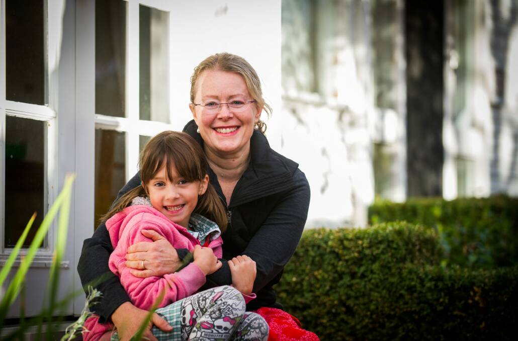 Canberra breast cancer survivor and photographer Marina McDonald with daughter Sydney Dayal, 7, at  home in Yarralumla. Photo: Elesa Kurtz