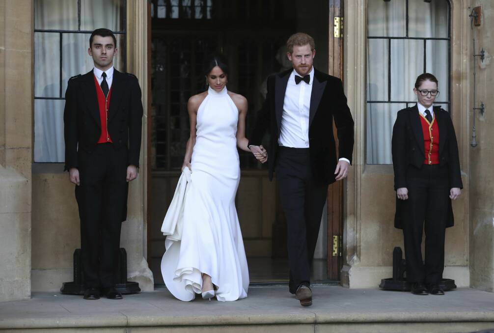 The newly married Duke and Duchess of Sussex, Meghan Markle and Prince Harry, leave Windsor Castle after their wedding.