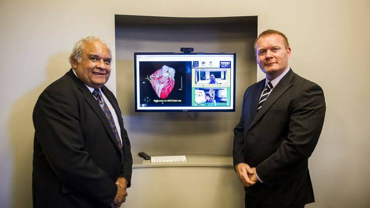 UC Chancellor Dr Tom Calma and Ochre Health chief executive John Burns with a new web-based terminal to be used for patient-doctor collaboration. Photo: Rohan Thomson