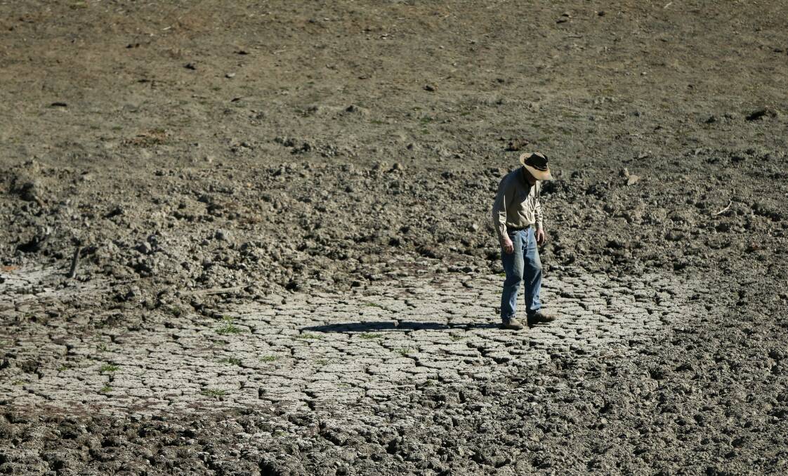 Bill Hannah in one of the four empty dams on his property in Gundy, in the Hunter region of NSW. Much of Australia is - yet again - in the grip of drought. Photo: Marina Neil