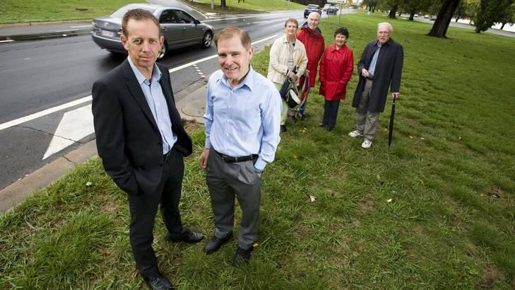 Minister for Territory and Municipal Services Shane Rattenbury talks to Barton residents Ian Pearson, Rewa and Graham Utley, Maureen Dowling and Bruce Pryor about an ACT Government trial of microsurfacing. Photo: Elesa Kurtz