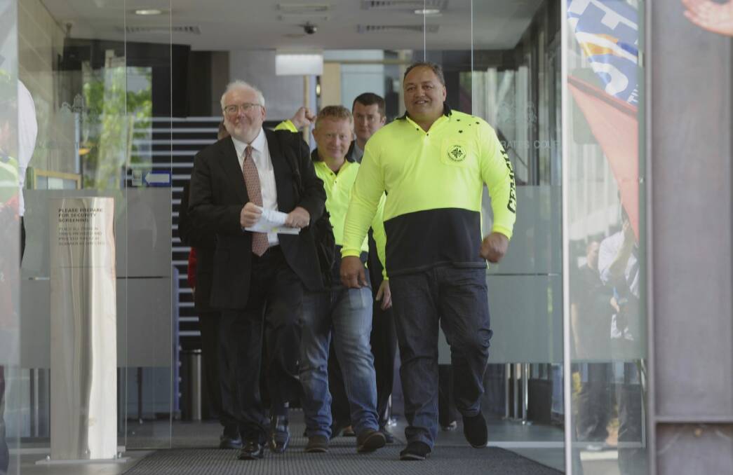 CFMEU organiser John Lomax, right, leaves the court with lawyer John Agius after having a blackmail charge dropped. Photo: Graham Tidy