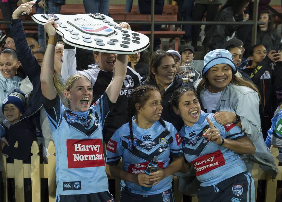 The Blues are presented with the Women's State of Origin shield. Photo: AAP