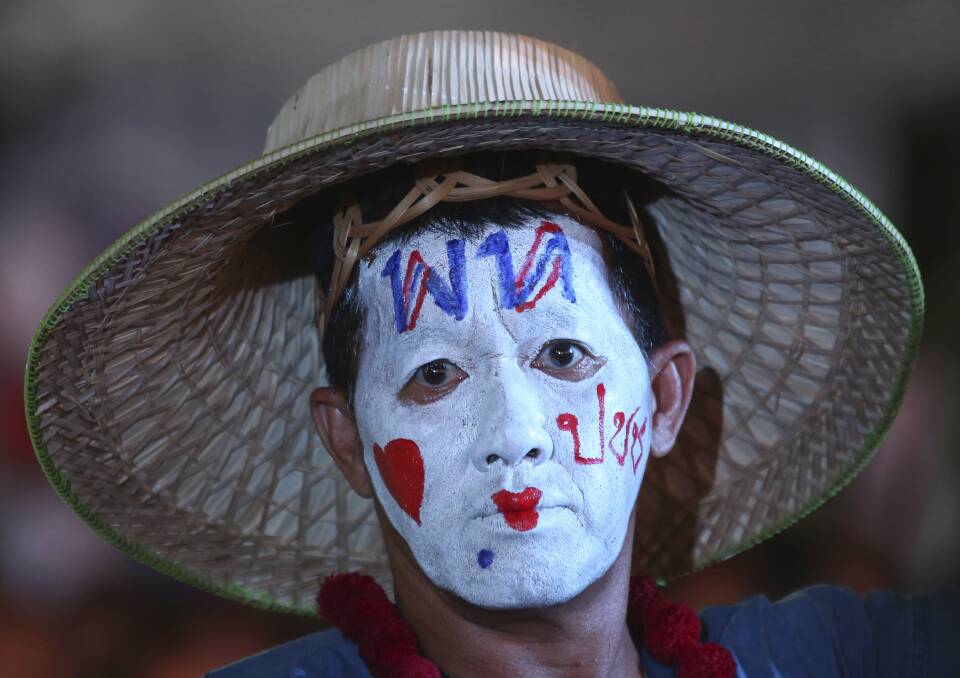 A supporter of Pheu Thai Party wears a message on his head reading "Pheu Thai Party love people" during an election campaign in Bangkok. Photo: AP