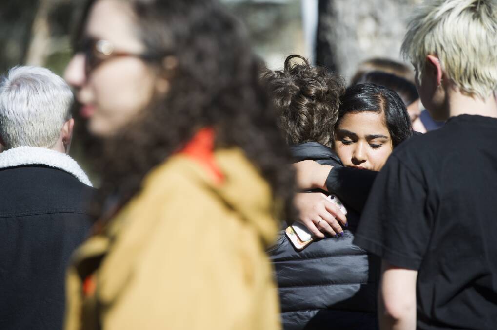 Survivors and students comfort each other as they call on ANU to do more, a year on from a landmark report into sexual violence on campus. Photo: Elesa Kurtz