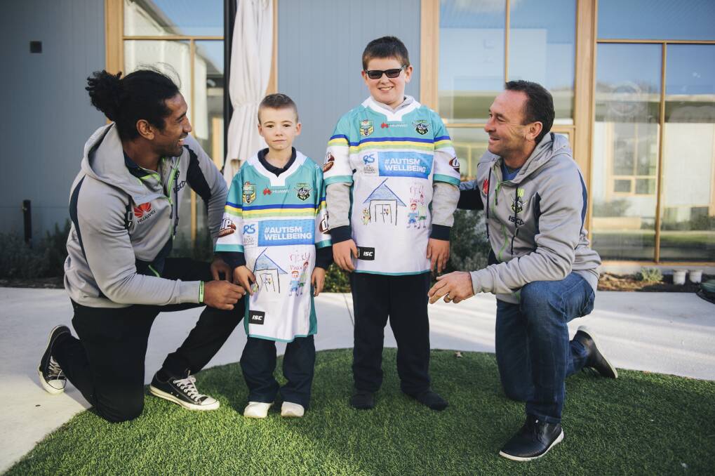 Sia Soliola and Ricky Stuart with Jayden and Max after they designed the Raiders jersey in 2017. Photo: Rohan Thomson