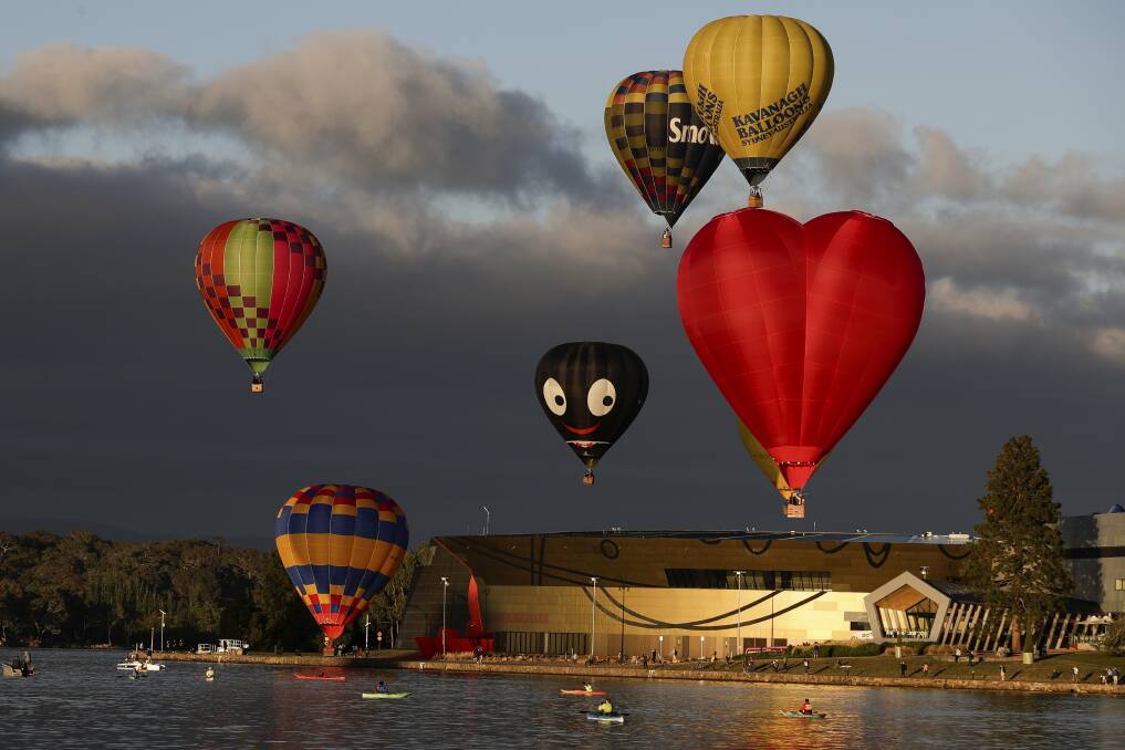 Hot air balloons, including Golly, flying past the National Museum at the 2018 Balloon Spectacular. Photo: Alex Ellinghausen