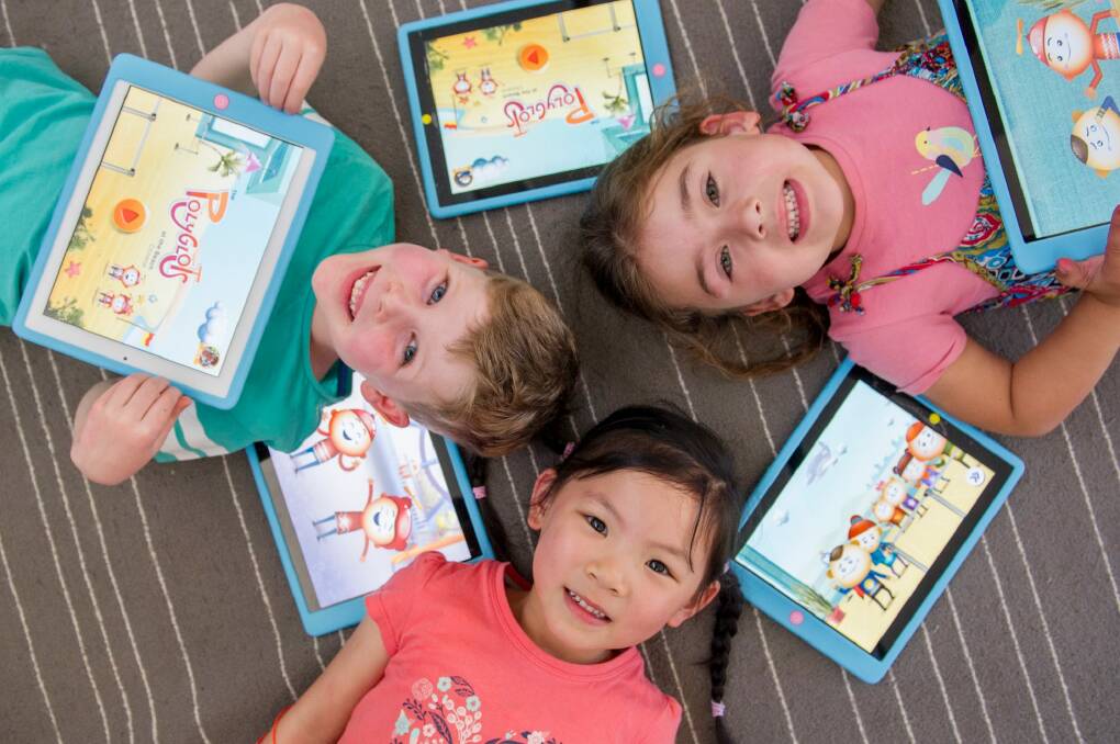 Mawson Preschool students Tommy McCorry, Zoe McDonald and Ella Chew are learning mandarin with the help of a federal government iPad app.  Photo: Jay Cronan