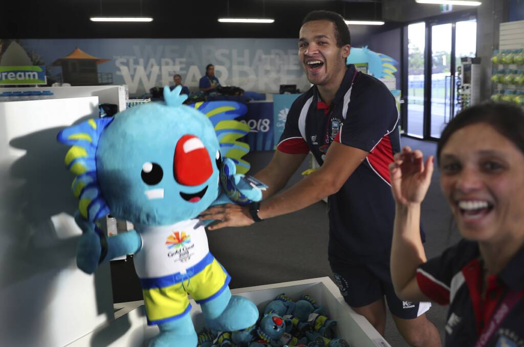 Athletes from the Falkland Islands play with Commonwealth Games mascot Borobi in the Games village. Photo: AP Photo/ Manish Swarup