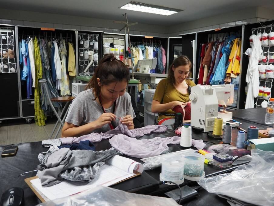 Wardrobe specialist Audray Auclair (right) from Canada fixing an aerial hoop handmade headpiece in the wardrobe department with a local assistant in Bangkok. Photo: Clare Colley