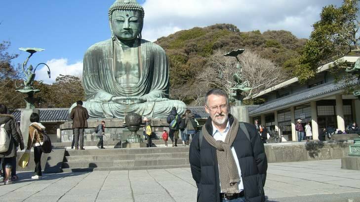 Dr Michael Pearson in front of the Amitabha Buddha, Kamakura, Japan. Photo: Supplied