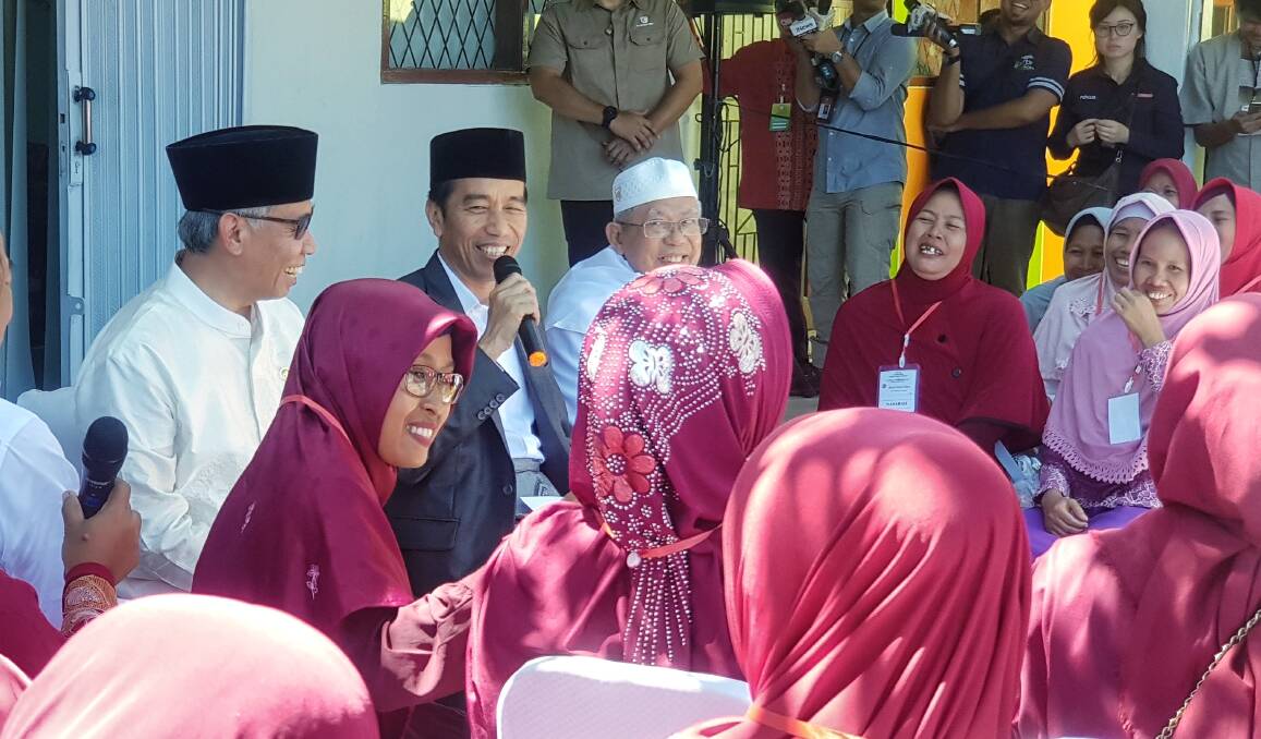 Joko Widodo addresses residents in Serang, Banten, accompanied by the chairman of the Financial Services Authority, Wimboh Santoso, and the head of Indonesian Ulema Council Ma'ruf Amin.  Photo: Amilia Rosa