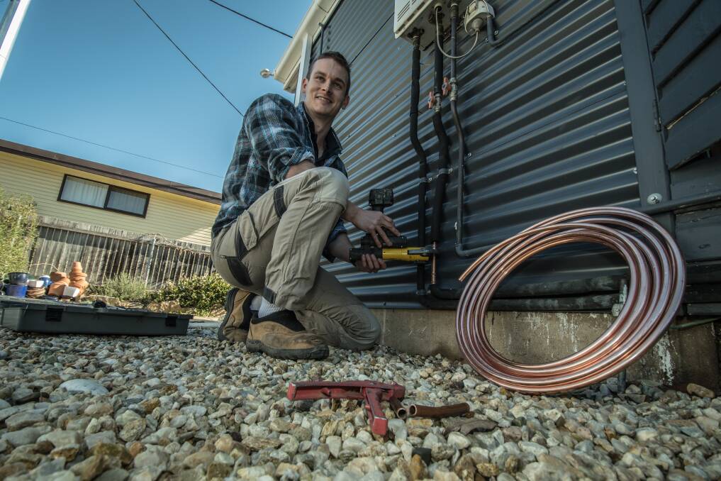 Plumber Andrew McReynolds  fixes burst pipes in O'Connor after sub-zero winter temperatures. Photo: Karleen Minney