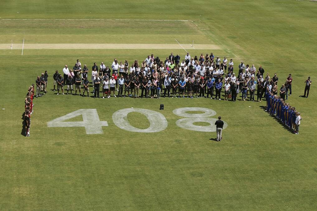 SACA staff along with women's cricket teams, SA and ACT, hold a minute of silence before the WNCL game at the Adelaide Oval around the number 408 which was Phil Hughes' test cap number. Photo: Getty Images