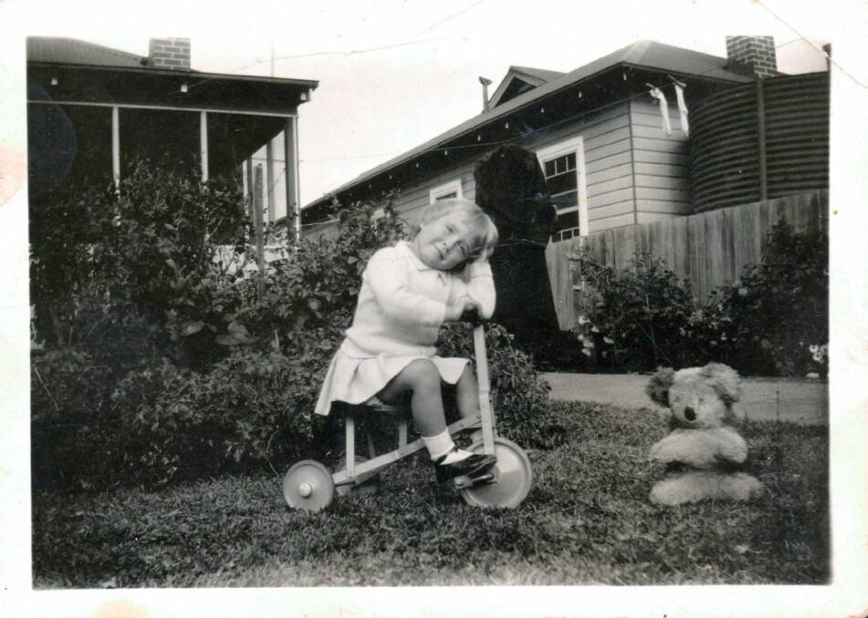 Lesley Cunich, three years old, with tricycle and teddy, from the doco about her life made by Simon Cunich.
