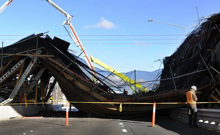 An inspector examines part of a bridge which collapsed on the Gungahlin Drive Extension over the Barton Highway in North Canberra in 2010. Picture: Lannon Harley