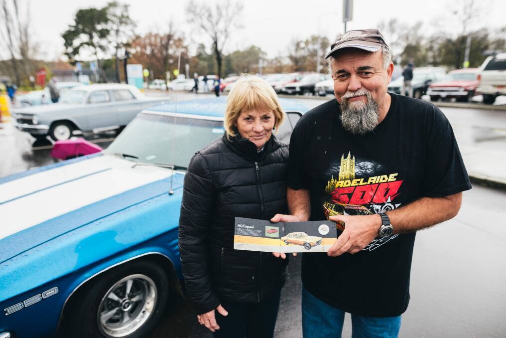 Pam and John Daniel from Muswellbrook with their 1973 Holden HQ and the matching coin at the Royal Australian Mint.  Photo: Rohan Thomson