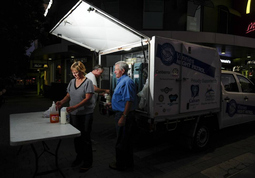 Vinnies Night Patrol van team leaders Therese Edwards, front, and,  back from left, Brian Kinnane and Peter Kinnane set up near Garema Place in Civic. Photo: Melissa Adams