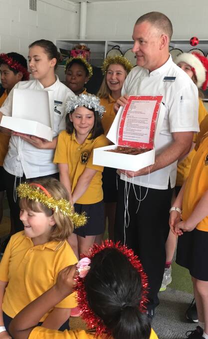 Calli from Weetangera School only had eyes for the brownies when Executive Chef from Parliament House David Learmonth visited the school Photo: Supplied