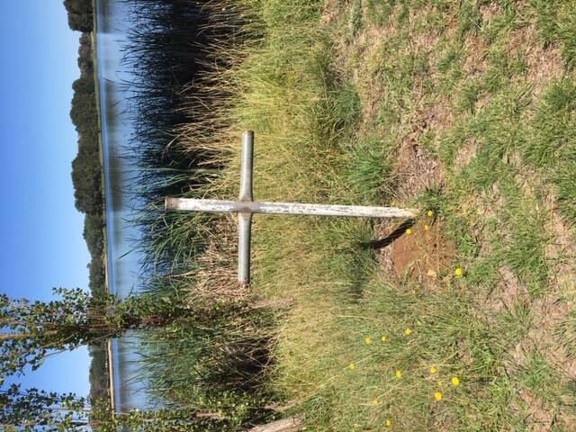 A metal cross near on the shores of Lake Ginninderra. Photo: Katy Skinner