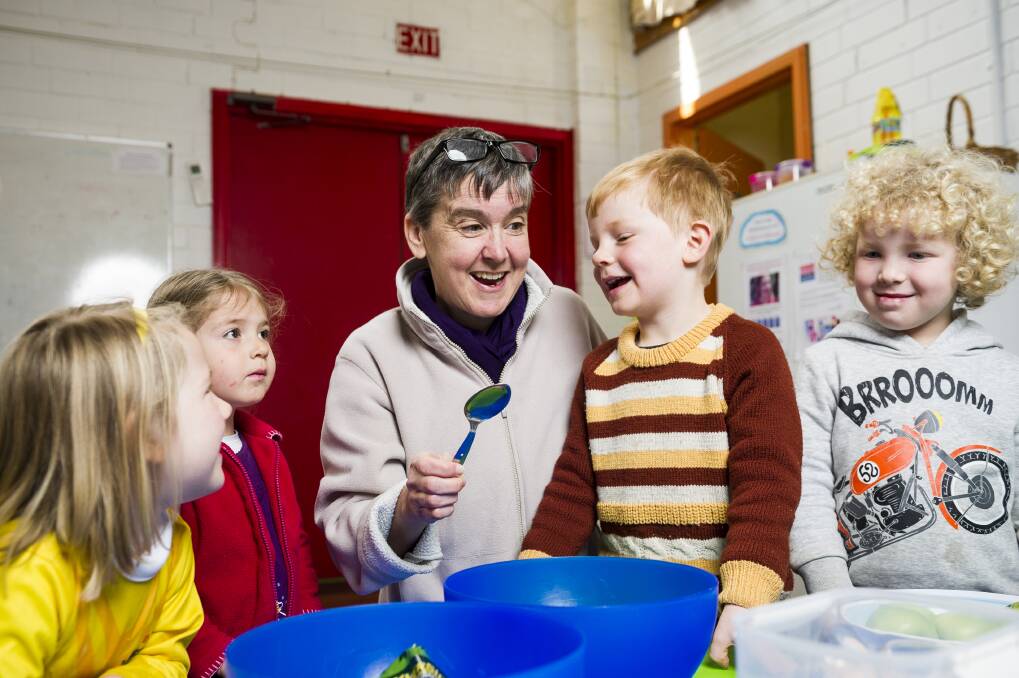 Director Lisa Stephan teaching students at the German Australian Playschool how to bake. The playschool has been given a lifeline to survive by being allowed to administer the new child care subsidy scheme. Photo: Dion Georgopoulos
