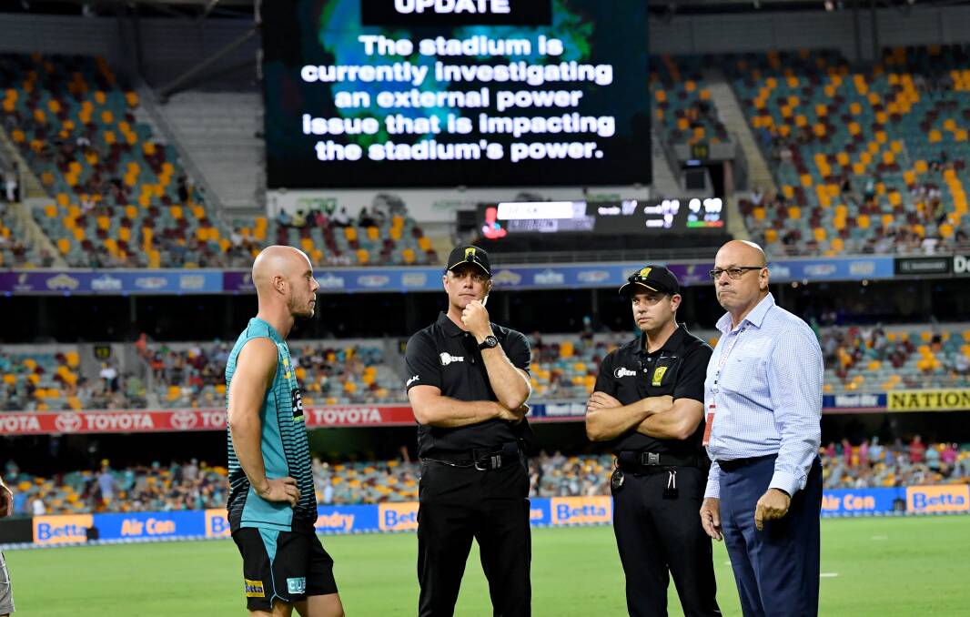 Chris Lynn (left) of the Heat is seen talking to the match officials after play was abandoned on Thursday night. Photo: Darren England - AAP