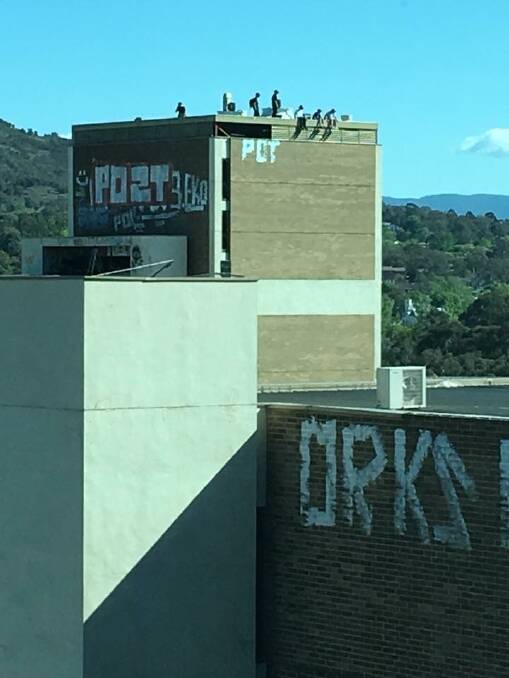 People on the roof of the abandoned Woden building on Monday afternoon. Photo: Supplied