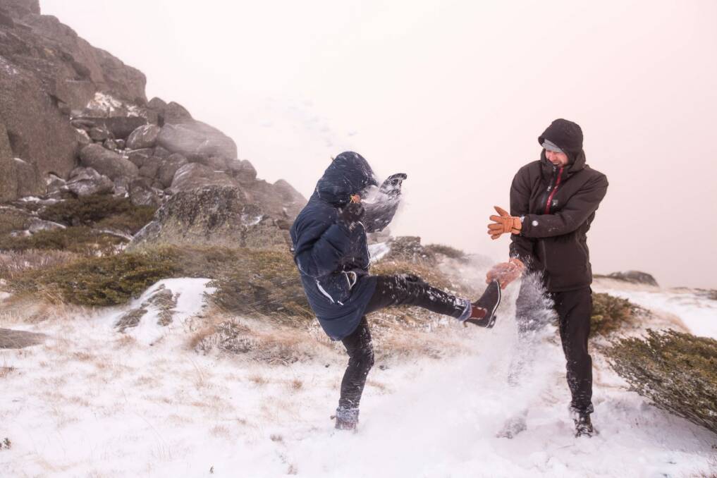 Tiggy Cameron and Luke Kneller have some fun after the first snow at Thredbo on May 11. Photo: Supplied
