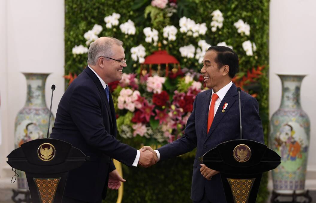 Prime Minister Scott Morrison with Indonesian President Joko Widodo at the Presidential Palace on Friday night. Photo: AAP