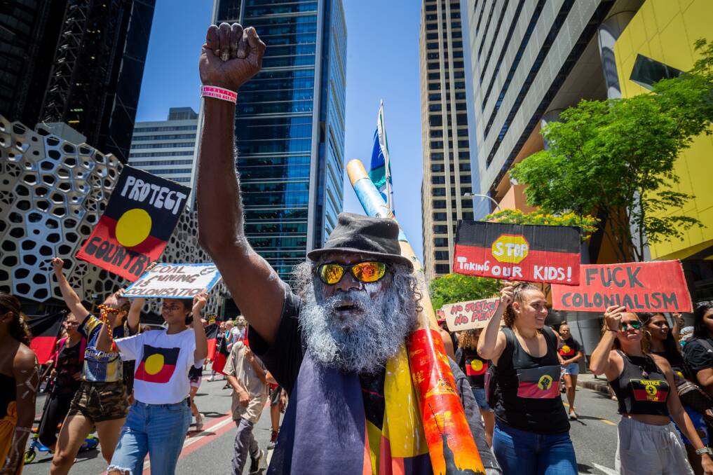 Invasion Day protesters march through the streets. Photo: AAP/Glenn Hunt.