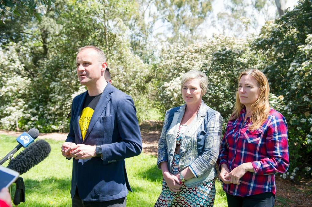 From left Chief Minister Andrew Barr, newcomer Bec Cody, and the likely deputy chief minister Yvette Berry celebrate their election win at Corroborree Park in Ainslie. Photo: Jay Cronan