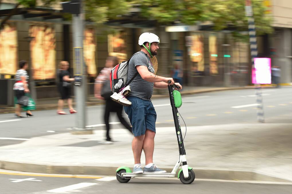 A Lime scooter user on the streets of Brisbane. Photo: AAP