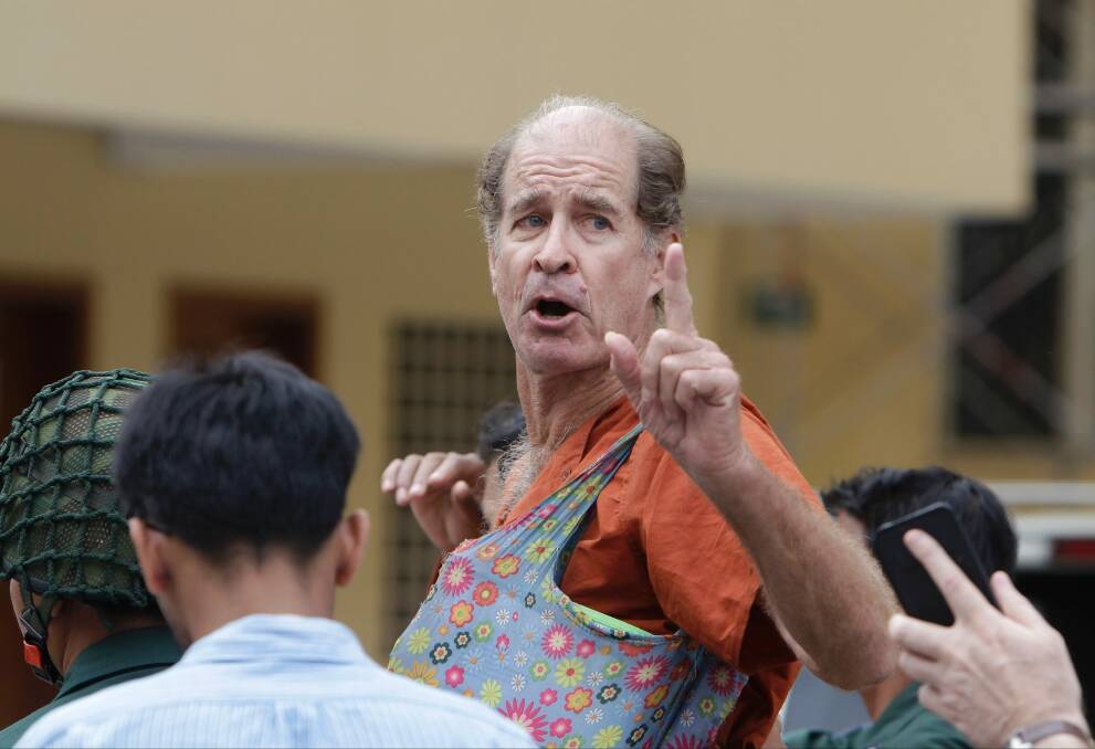 Australian filmmaker James Ricketson gestures as he is escorted by prison guards in January. Photo: AP