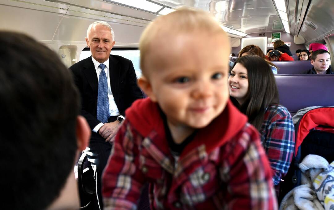 Prime Minister Malcolm Turnbull meets Ryan and Angel Johnson and their son Clark  on the train to Emu Plains in the marginal seat of Lindsay. Photo: AAP