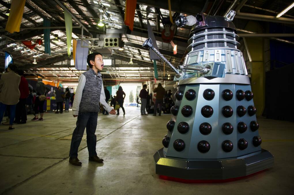 Kenneth Le, 10, with one of the Daleks that roamed the Old Bus Depot Markets.  Photo: Rohan Thomson