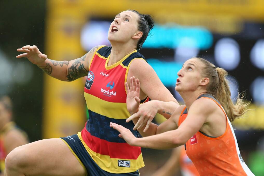 Rhiannon Metcalfe of the Crows competes with Clare Lawton of the Giants on Saturday. Photo: James Elsby/AFL Media