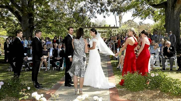 Heath Wells and Lauren Boden during their wedding at the Old Parliament House Rose Gardens. Photo: Jeffrey Chan