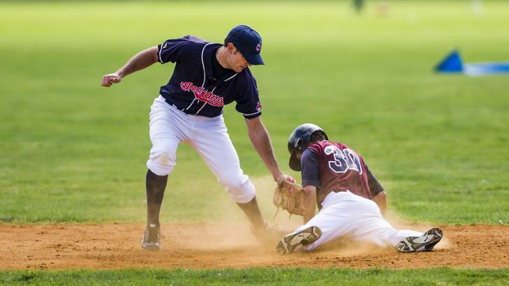 Woden's Julian Pozza dives for second base in front of Weston Creek's Cable Dohnt. Photo: Rohan Thomson