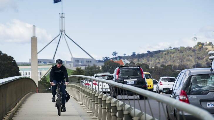 A cyclist rides on the eastern side of Commonwealth Avenue Bridge. Photo: Rohan Thomson