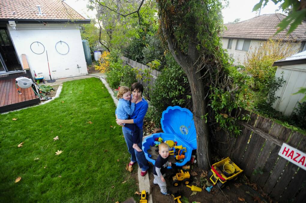 Suzanne Pippen with her children Dominic, 2, and Hannah, 4, in their Duffy backyard which adjoins perhaps two Fluffy properties. Photo: Melissa Adams